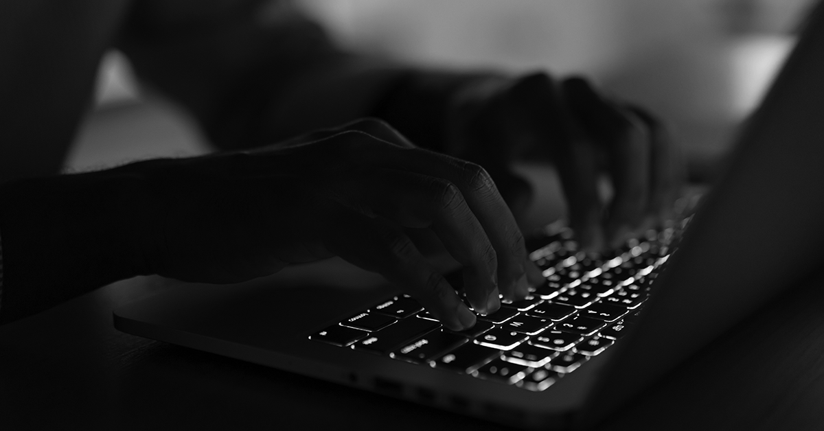 man writing on laptop